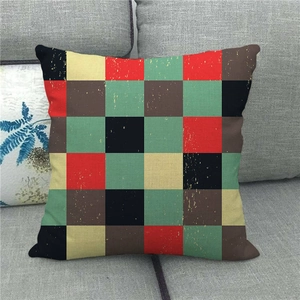 Close-up of retro checkered linen pillowcase with woven texture on a grey fabric sofa
