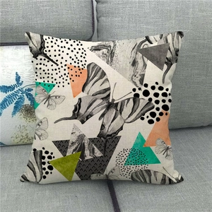 Detailed texture of linen throw pillow case featuring abstract butterfly and geometric design