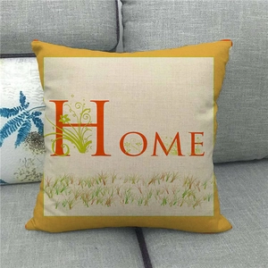 Detailed view of linen cushion cover texture with HOME lettering and floral print