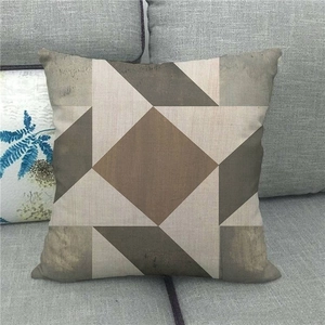 Detailed texture of linen cushion cover with modern brown and beige geometric pattern