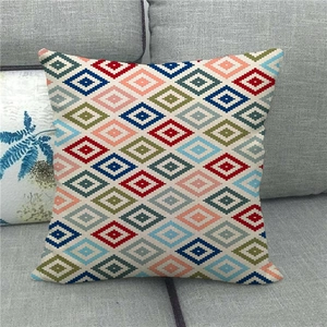 Close-up of geometric diamond pattern and woven linen texture on a colorful sofa cushion