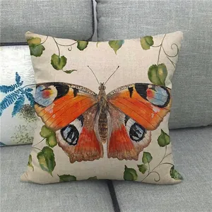 Detailed close-up of colorful butterfly and green leaves pattern on linen pillow cover
