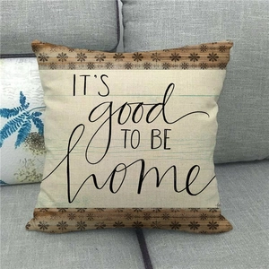 Close-up of linen pillow cover with printed text and brown floral geometric borders