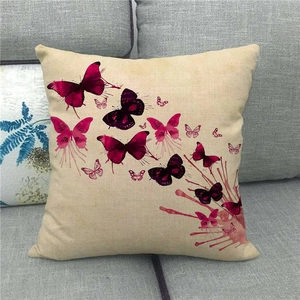 Linen decorative pillow cover featuring artistic purple butterfly splatter design on sofa