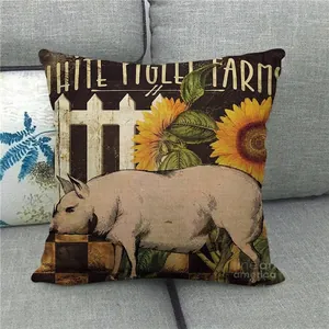 Detail of linen pillowcase with farm pig, sunflowers, and rustic fence on a sofa