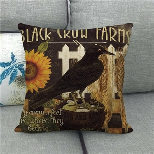Detail of vintage linen pillowcase featuring black crow, sunflowers, and farm theme