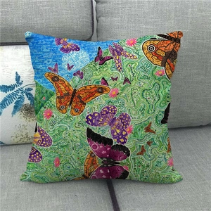 Close-up of linen pillowcase with colorful butterfly prints and artistic typography