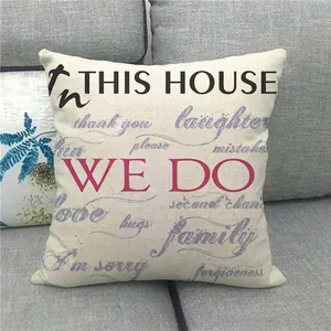 Modern linen pillowcase with family quotes and pink accents on a gray sofa