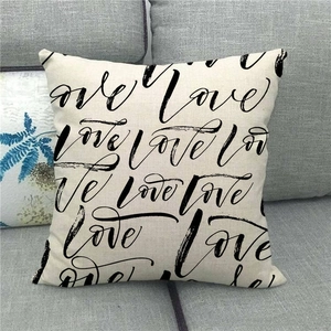 Detail of linen pillowcase featuring artistic repeating black Love script pattern