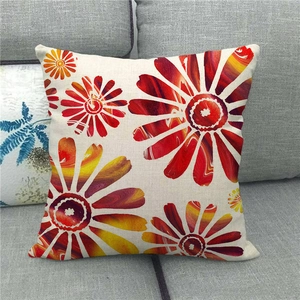 Linen pillow cover with colorful geometric daisy patterns on a gray sofa background