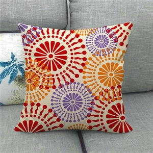 Close-up of linen cushion cover featuring colorful geometric floral patterns and seam details