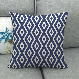 Close-up of the rough linen texture and navy blue geometric diamond pattern on the pillowcase
