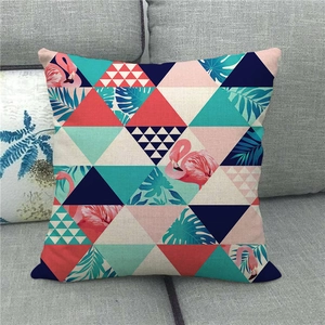 Close-up of geometric linen pillow cover with flamingo and palm leaf print texture