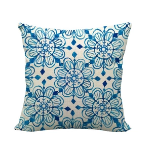 Linen throw pillow cover with blue floral geometric pattern on white background