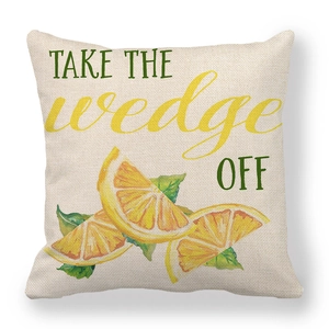 Detail of linen cushion cover showing yellow lemon print and take the wedge off text