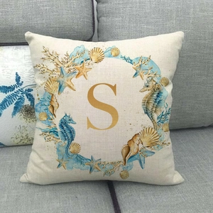 Detailed view of linen pillow cover with marine sea horse starfish print and letter S