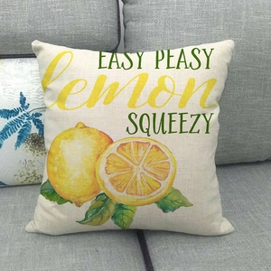 Linen lemon cushion cover with 'Easy Peasy' text on a gray sofa for home decor