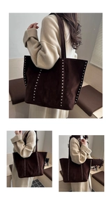 Macro detail of brown suede tote bag featuring silver studs and long shoulder straps