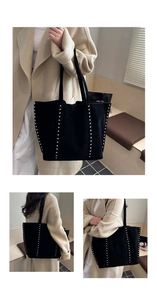 Detail view of large black suede tote bag with stylish vertical silver metal rivets