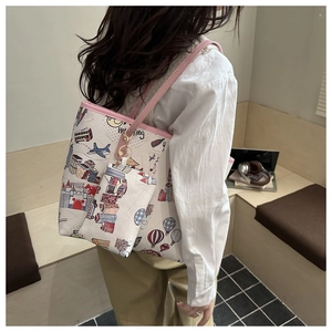 Detail of canvas tote bag featuring city travel illustrations and a matching small coin purse