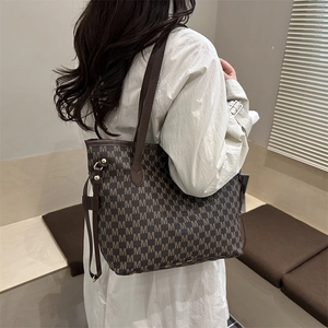 Brown tote bag with repetitive M letter texture for stylish women's daily commuting