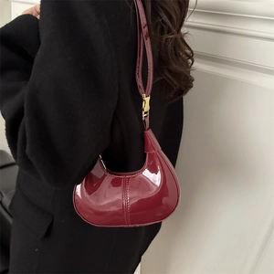 Burgundy patent leather crescent hobo bag with adjustable gold buckle for women