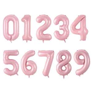Close-up of pink 40-inch foil number balloons from 0 to 9 for birthday parties