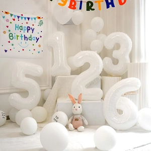 White birthday balloon set with large foil numbers and printed latex balloons on display