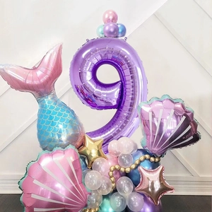 Detail of 9th birthday mermaid balloon kit with purple number nine and seashell decor