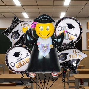 Detail of graduation foil balloons set featuring scholar figure and gold star decorations