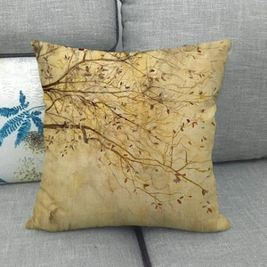 Square linen pillowcase featuring autumn yellow oil painting leaf patterns on a grey sofa
