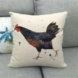 Detailed texture of linen pillowcase with colorful watercolor rooster print on grey sofa