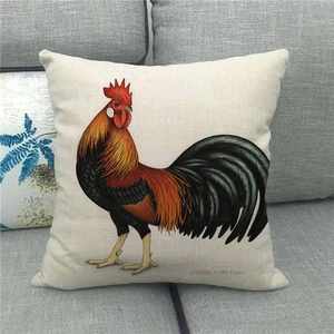 Detailed watercolor rooster painting on a beige linen cushion cover placed on a grey sofa
