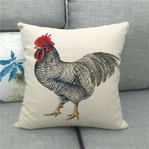 Detail of rustic rooster watercolor print on natural linen throw pillow cover on sofa