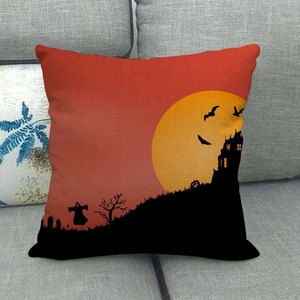 Halloween linen pillowcase with spooky castle and bat silhouette on a gray sofa