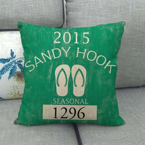 Linen style decorative square pillow with green sandy hook seasonal flip flop design