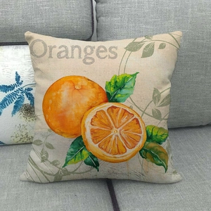 Detailed texture of linen pillowcase with retro orange print on a grey sofa