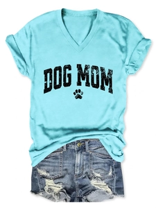 Flat lay of a light blue V-neck Dog Mom T-shirt with distressed denim shorts