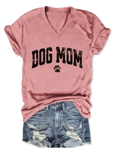 Flat lay of pink V-neck Dog Mom T-shirt and distressed light blue denim shorts