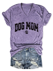 Close-up of purple V-neck T-shirt with black Dog Mom print and hollow paw design