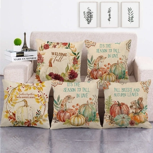 Set of five autumn watercolor pumpkin and hedgehog linen pillow covers on a sofa