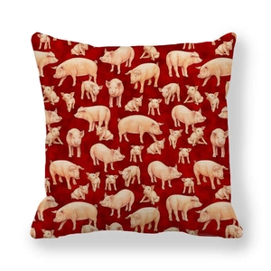 Close-up detail of linen pillow cover with vibrant red base and pink pig pattern print