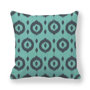 Minimalist geometric teal square cushion cover with grey Ikat circular pattern on white backdrop