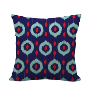 Linen pillowcase with blue geometric circular patterns and red diamond motifs on white background