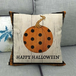 Detail of linen pillowcase with orange polka dot pumpkin and Happy Halloween text