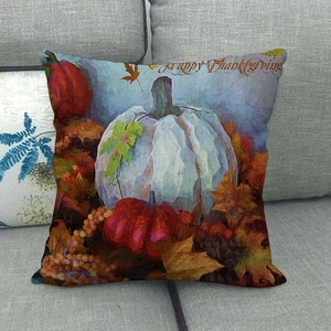 Close-up of Happy Thanksgiving linen pillowcase with colorful pumpkins on grey sofa