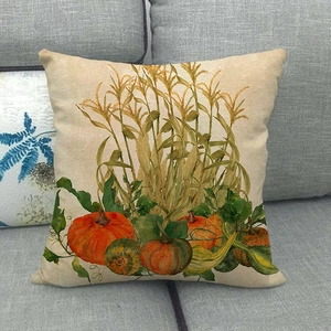 Detailed close-up of a rustic linen pillowcase featuring painted autumn pumpkins on a sofa
