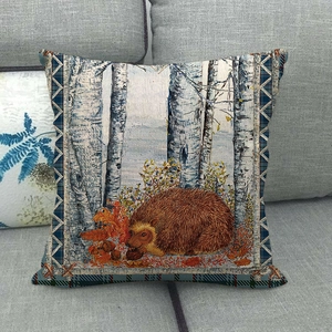 Detail of linen pillow cover featuring hedgehog and birch tree art with plaid piping