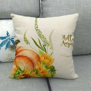 Autumn linen pillowcase with watercolor pumpkin, sunflower and Hello August text on sofa