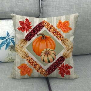 Linen pillow cover with pumpkin and maple leaf harvest pattern on a grey sofa